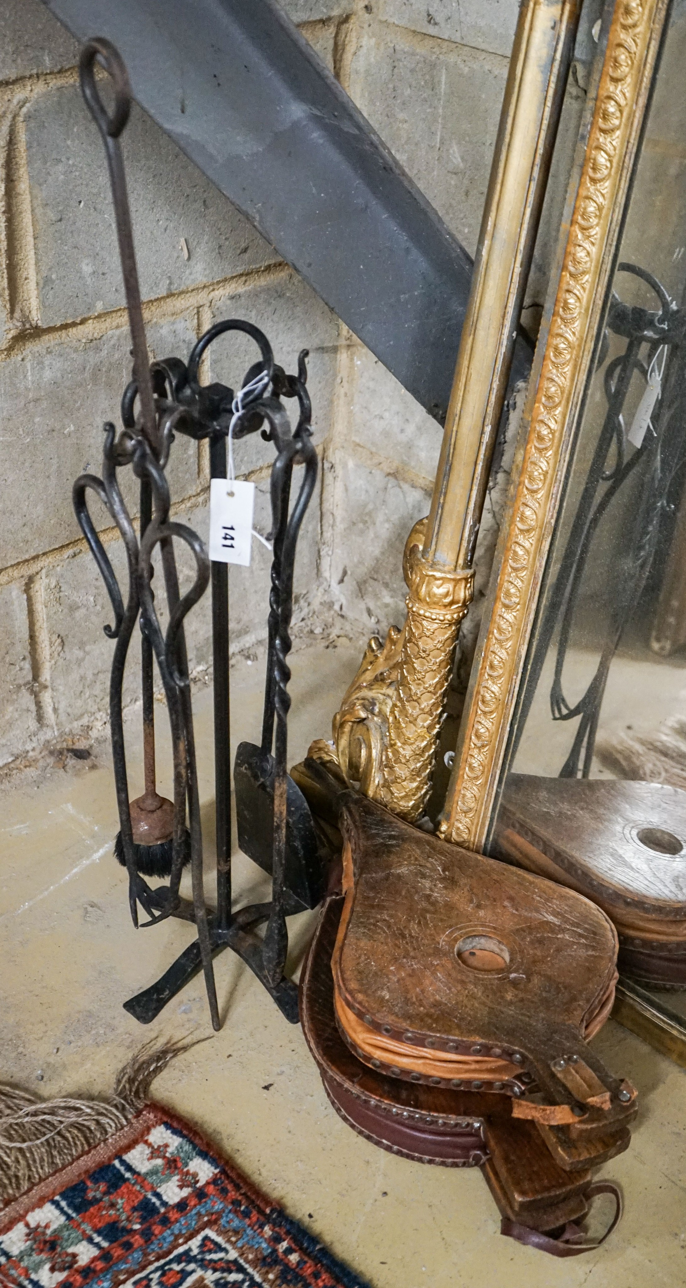 Two antique bellows and a companion set of fireplace tools